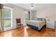 Comfortable bedroom boasts hardwood floors, large windows, and ample natural light at 124 Courtney Ln, Matthews, NC 28105