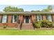 Close up of the brick front of the house, with stairs leading to a decorative front door at 124 Courtney Ln, Matthews, NC 28105