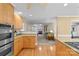 Well-lit kitchen featuring wooden cabinets, stainless steel appliances, and a view to the living room at 124 Courtney Ln, Matthews, NC 28105