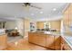 Open-concept kitchen with wooden cabinets, island cooktop, hardwood floors, leading to dining and living areas at 124 Courtney Ln, Matthews, NC 28105