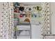 Laundry room equipped with washer, dryer, water heater, storage shelves and a leaf-patterned shower curtain at 124 Courtney Ln, Matthews, NC 28105