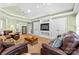Comfortable living room includes vaulted ceiling, built-in shelving, and recessed lighting at 124 Courtney Ln, Matthews, NC 28105