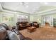 Inviting living room featuring neutral walls, ceiling fans and comfortable leather seating at 124 Courtney Ln, Matthews, NC 28105