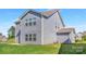 Back exterior of house with a well-kept green lawn and manicured yard at 129 Canada Dr # 85, Statesville, NC 28166