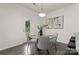 Modern dining room features round glass table with seating for four, complemented by stylish art at 129 Canada Dr # 85, Statesville, NC 28166