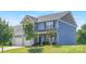 Attractive home with light blue siding, a two-car garage, and a well-maintained front yard with mature trees at 129 Canada Dr # 85, Statesville, NC 28166