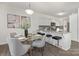 Open concept kitchen with granite countertops, stainless appliances, and island seating adjacent to the dining area at 129 Canada Dr # 85, Statesville, NC 28166