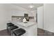 Bright kitchen features white cabinetry, granite countertops, stainless steel appliances, and breakfast bar seating at 129 Canada Dr # 85, Statesville, NC 28166