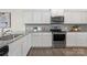 Modern kitchen with white cabinets, stainless steel appliances, and granite countertops, perfect for cooking at 129 Canada Dr # 85, Statesville, NC 28166