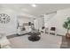 Spacious open-concept living room with modern furnishings, wood floors, and views of the kitchen and staircase at 129 Canada Dr # 85, Statesville, NC 28166
