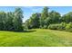 Beautiful green lawn with mature trees is ready for new construction and outdoor activities at 129 Canada Dr # 85, Statesville, NC 28166