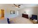 Spacious bedroom with a ceiling fan, complemented by a dark wood dresser and blue accent chair at 133 Way Cross Ln, Troutman, NC 28166