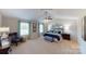 Airy bedroom features large windows, a ceiling fan, and a blue comforter with lots of pillows at 133 Way Cross Ln, Troutman, NC 28166