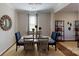 Elegant dining room with neutral walls, decorative mirror, area rug and contemporary table set at 133 Way Cross Ln, Troutman, NC 28166