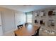 Dining room showcasing cabinet options, neutral walls, a bright window and a wooden table with modern chairs at 133 Way Cross Ln, Troutman, NC 28166
