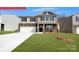 Charming two-story home with stone accents, a well-manicured lawn, and an attached two-car garage at 133 Way Cross Ln, Troutman, NC 28166