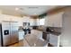 Modern kitchen featuring white cabinets, stainless steel appliances, and a granite island at 133 Way Cross Ln, Troutman, NC 28166