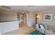 Living room featuring neutral walls and carpeting, gray sofa with pillows, and adjacent open bathroom at 133 Way Cross Ln, Troutman, NC 28166