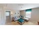 Open living room featuring a gray sofa, bright window, and stylish turquoise ottoman at 133 Way Cross Ln, Troutman, NC 28166