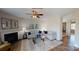 Inviting living room featuring hardwood floors, a fireplace, and a modern glass table at 133 Way Cross Ln, Troutman, NC 28166