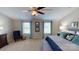 This is a bright main bedroom with two large windows, coordinated décor, and a ceiling fan at 133 Way Cross Ln, Troutman, NC 28166