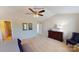 This is a large main bedroom with a ceiling fan, dark wood furniture, and doorways to other rooms at 133 Way Cross Ln, Troutman, NC 28166