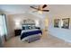 This is a well-lit main bedroom with neutral walls, a ceiling fan, and an adjoining bathroom entrance at 133 Way Cross Ln, Troutman, NC 28166