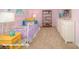 Bright bedroom featuring carpet and an open shelving unit for storage and decor at 136 Mary Locke Way, Statesville, NC 28677