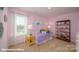 Stylish bedroom with pink walls, a metal bed frame, and decorative accents at 136 Mary Locke Way, Statesville, NC 28677