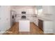 Modern kitchen with white cabinets, stainless steel appliances, granite countertops, and kitchen island at 136 Mary Locke Way, Statesville, NC 28677