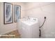 Functional laundry room with a washer, dryer, and overhead shelving for storage at 136 Mary Locke Way, Statesville, NC 28677