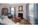 Well-lit living room featuring a fireplace, comfortable seating, and elegant window treatments at 136 Mary Locke Way, Statesville, NC 28677
