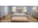 Lovely bedroom featuring blue walls, two bedside tables, carpet flooring, and tufted bench at 136 Mary Locke Way, Statesville, NC 28677