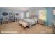 Serene bedroom featuring blue walls, neutral decor, two windows, and carpet floors at 136 Mary Locke Way, Statesville, NC 28677