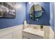 Cozy bathroom with blue walls and a white sink, complemented by an ornate mirror and accent painting at 1485 20Th Ne Ave, Hickory, NC 28601