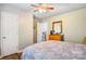 Bedroom with a door and laminate floors, with a queen bed, and a ceiling fan at 1485 20Th Ne Ave, Hickory, NC 28601