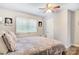 Bedroom with a window, laminate floors, with a queen bed, and a ceiling fan at 1485 20Th Ne Ave, Hickory, NC 28601