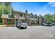 Townhome exterior featuring brick accents, red shutters, and a well-maintained parking area at 1485 20Th Ne Ave, Hickory, NC 28601