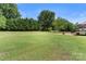 Expansive backyard featuring a verdant lawn, mature trees, and a charming patio area at 1498 Farrow Dr, Rock Hill, SC 29732