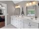 Bathroom with double sink, mirrors, white cabinets and tile floors at 1498 Farrow Dr, Rock Hill, SC 29732
