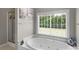 Large soaking tub, shower, and serene window view complete the tranquil bathroom at 1498 Farrow Dr, Rock Hill, SC 29732