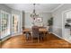Dining room featuring hardwood floors, a modern chandelier, and a large window for natural light at 1498 Farrow Dr, Rock Hill, SC 29732