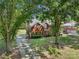 Charming brick home with mature trees and a lush green lawn creates a welcoming curb appeal at 1498 Farrow Dr, Rock Hill, SC 29732