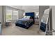 Elegant bedroom featuring a blue tufted headboard and neutral decor at 15021 Meacham Farm Dr, Huntersville, NC 28078