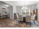 Elegant dining room featuring a glass table, chandelier, decor and access to a bright window with outdoor views at 15021 Meacham Farm Dr, Huntersville, NC 28078