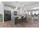 Modern kitchen with stainless steel appliances, granite countertops, island with seating, and an open layout at 15021 Meacham Farm Dr, Huntersville, NC 28078
