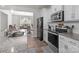 Well-lit kitchen featuring granite countertops, stainless steel appliances, and an open layout to the dining area at 15021 Meacham Farm Dr, Huntersville, NC 28078