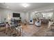 Bright and open living room with modern decor, hardwood floors, and a view into the kitchen at 15021 Meacham Farm Dr, Huntersville, NC 28078