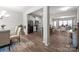 Open-concept living space with hardwood floors, neutral tones, seamless transition to the kitchen and dining areas, and lots of light at 15021 Meacham Farm Dr, Huntersville, NC 28078