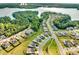 Aerial view of homes nestled in a community beside a lake surrounded by lush greenery and mature trees at 15429 Topanga Dr, Charlotte, NC 28278